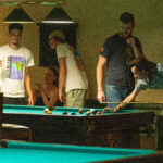 group playing pool